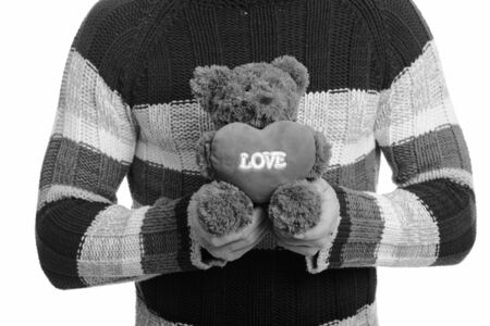 Caucasian man holding teddy bear with love and heart signの写真素材