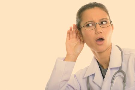 Close up of young beautiful woman doctor listening