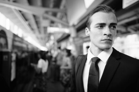 Young handsome businessman in suit exploring the cityの写真素材