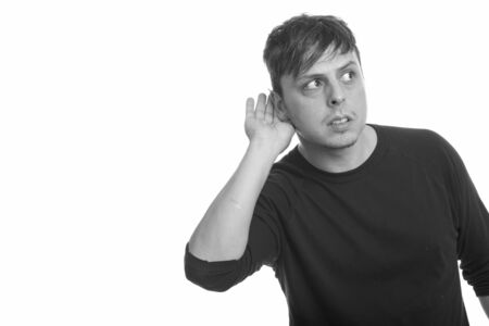 Studio shot of man listening in black and white