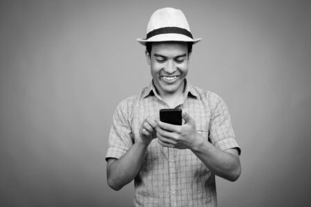 Portrait of young Asian tourist man using phone ready for vacationの写真素材