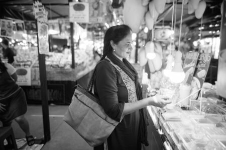 Portrait of mature beautiful Indian woman exploring the cityの写真素材
