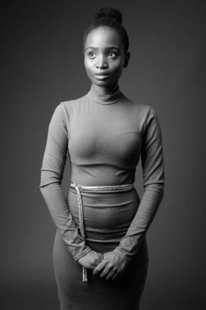 Young beautiful African Zulu businesswoman against gray backgroundの写真素材