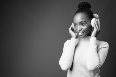 Young beautiful African Zulu businesswoman against gray backgroundの写真素材