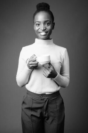 Young beautiful African Zulu businesswoman against gray backgroundの写真素材