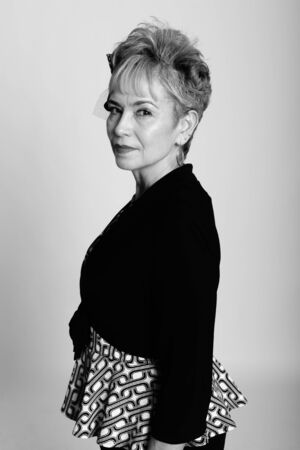 Studio shot of senior Asian businesswoman against gray background