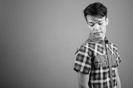 Portrait of young handsome Asian teenage boyの写真素材