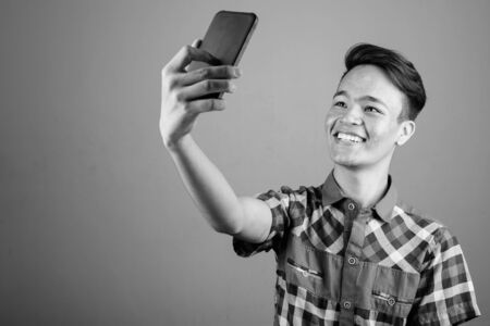 Portrait of young handsome Asian teenage boyの写真素材