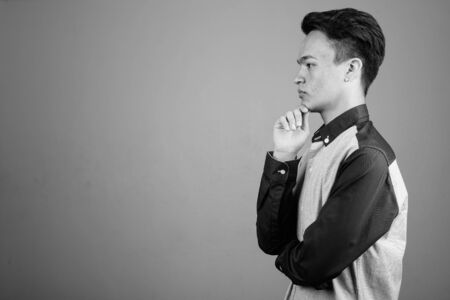 Portrait of young handsome Asian teenage boy looking smartの写真素材