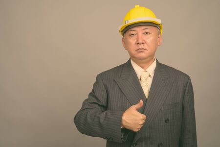 Portrait of mature Asian businessman as engineerの写真素材