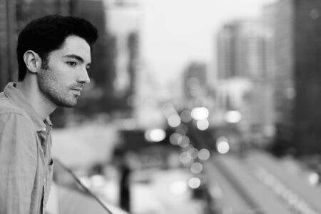 Portrait of young handsome businessman exploring the cityの写真素材