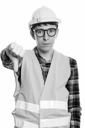 Portrait of man construction worker with eyeglasses giving thumbs downの写真素材