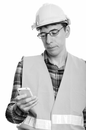 Portrait of man construction worker using phoneの写真素材