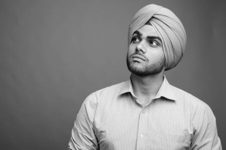 Young handsome Indian Sikh businessman wearing turbanの写真素材