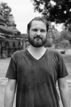 Portrait of young bearded tourist man having vacationの写真素材