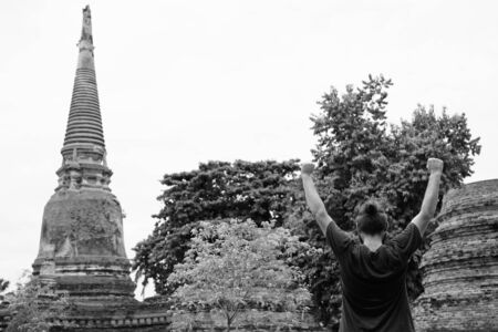 Portrait of young bearded tourist man having vacationの写真素材