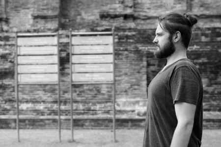 Portrait of young bearded tourist man having vacationの写真素材