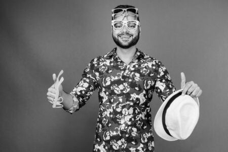 Young bearded Indian tourist man against gray background