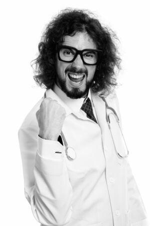 Studio shot of happy man doctor smiling and looking motivatedの写真素材