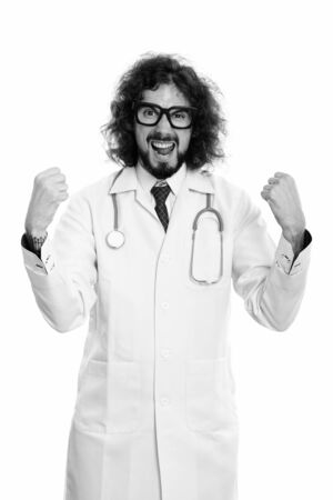 Studio shot of happy man doctor smiling looking excitedの写真素材