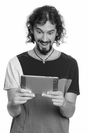 Happy handsome Caucasian man holding digital tabletの写真素材