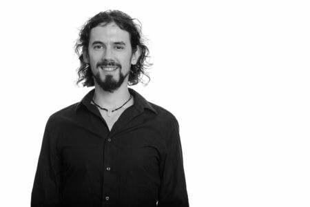 Portrait of happy handsome bearded businessman smilingの写真素材