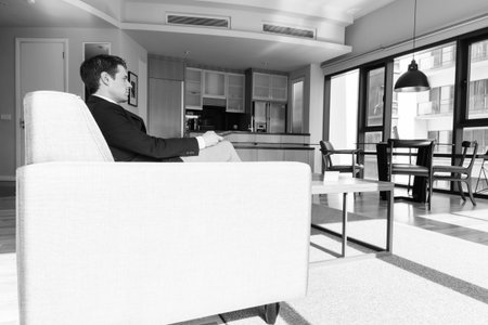 Young handsome businessman relaxing in the living room
