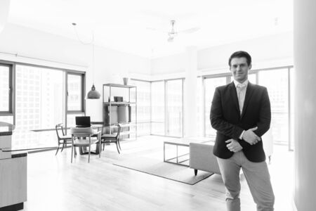 Young handsome businessman relaxing in the living roomの写真素材