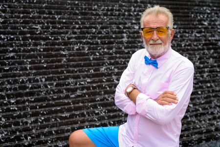 Handsome senior tourist man exploring the city of Bangkok, Thailの写真素材
