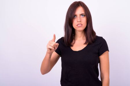 Portrait of stressed young woman pointing at cameraの写真素材