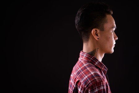 Closeup profile view of young handsome Indian hipster man