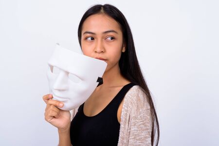 Portrait of young beautiful Asian woman with maskの写真素材