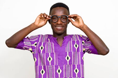 Portrait of happy young African man in traditional clothingの写真素材