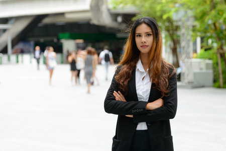 Young beautiful Asian businesswoman in the city streetsの写真素材
