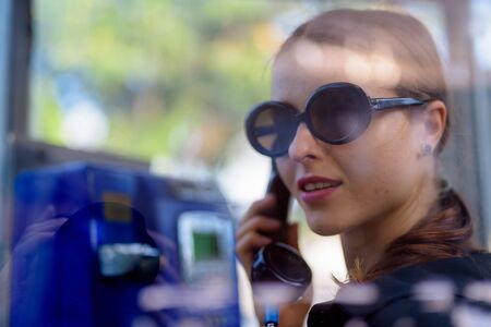 Portrait of young beautiful woman in the city streets outdoorsの写真素材