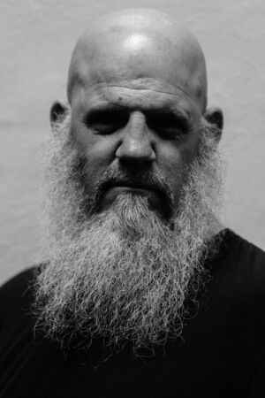 Face of serious mature bald bearded man in black and whiteの写真素材