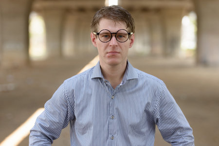 Young handsome blond businessman in the streets outdoorsの写真素材