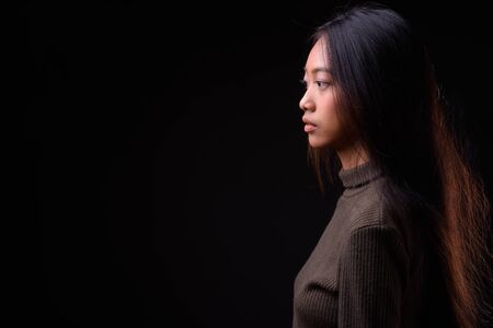 Profile view of young beautiful Asian womanの写真素材