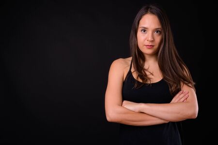 Young multi ethnic beautiful woman against black backgroundの写真素材