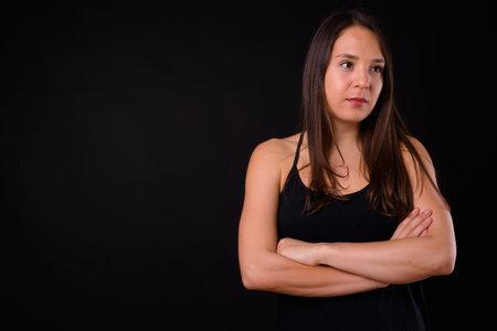 Young multi ethnic beautiful woman against black backgroundの写真素材