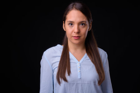 Young multi ethnic beautiful businesswoman against black background