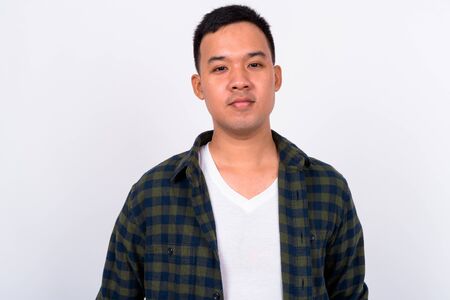 Face of young Asian hipster man looking at cameraの写真素材