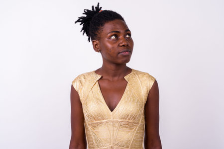 Portrait of young beautiful African woman thinking
