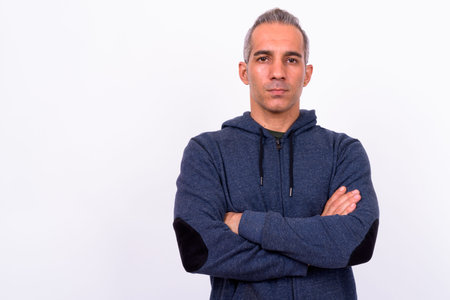 Portrait of Persian man wearing hoodie with arms crossed