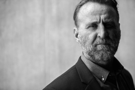 Face of mature handsome bearded businessman in black and whiteの写真素材