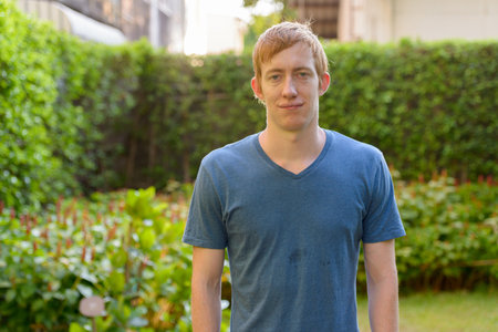 Portrait of man with red hair relaxing in the parkの写真素材