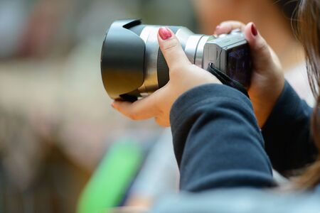 Hand of overweight woman taking picture with camera at cafeの写真素材