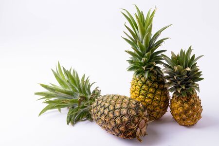 Ripe Pineapples Of Different Sizes Against White Backgroundの写真素材