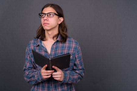 Young handsome hipster man with long hair