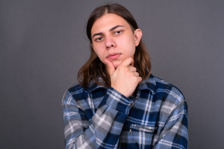 Young handsome hipster man with long hair